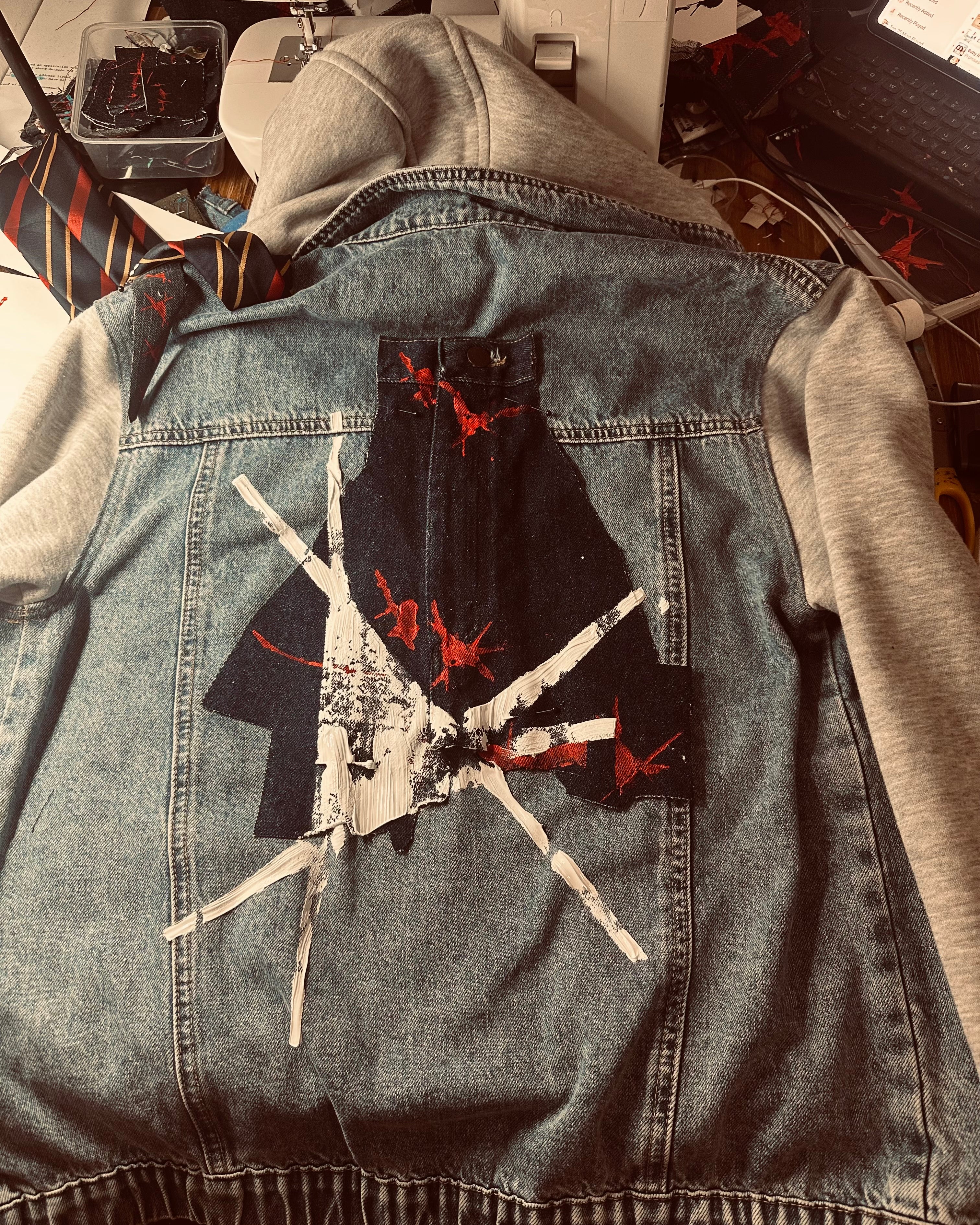 reclaimed jacket embellished with paint and thread by Jay Jackal