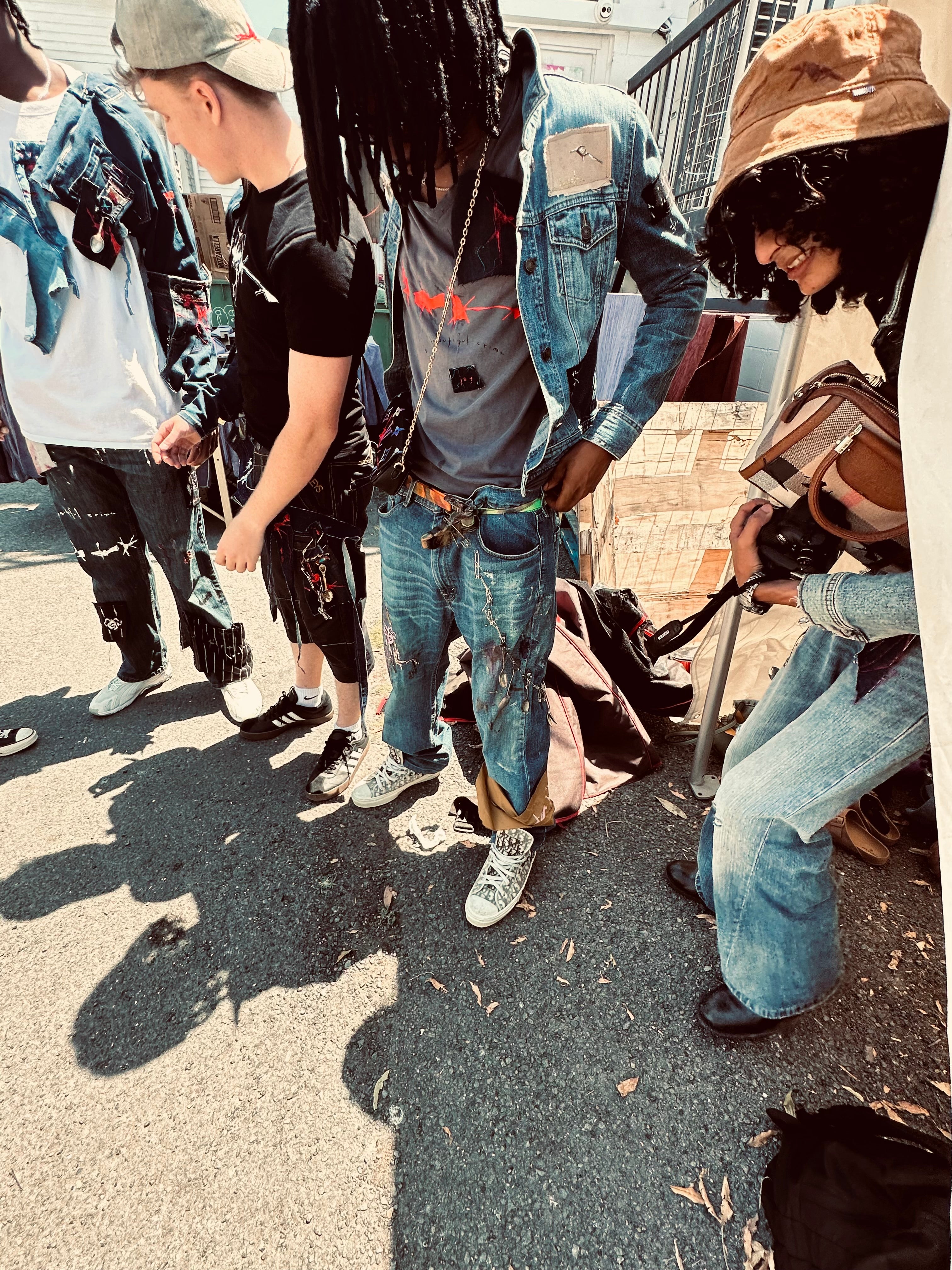 Group of people standing on the street wearing Jay Jackal Streetwear collection